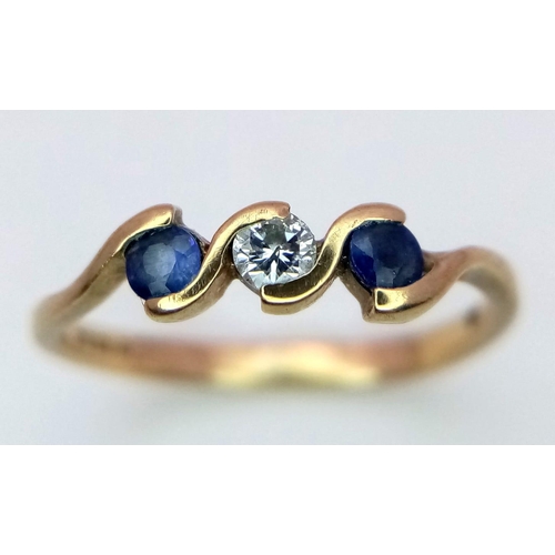 912 - A 9K Yellow Gold Diamond and Sapphire Ring set in a Wave Pattern. Size K 1/2. 1.25g weight.