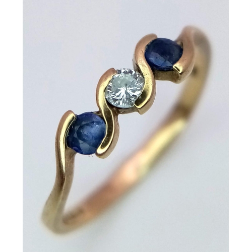 912 - A 9K Yellow Gold Diamond and Sapphire Ring set in a Wave Pattern. Size K 1/2. 1.25g weight.