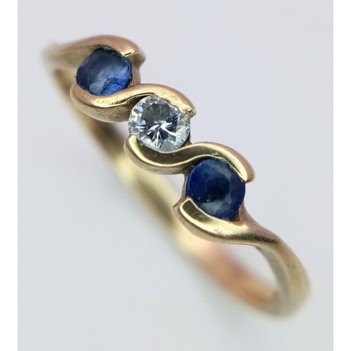 912 - A 9K Yellow Gold Diamond and Sapphire Ring set in a Wave Pattern. Size K 1/2. 1.25g weight.