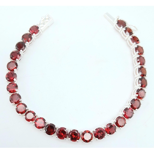 1190 - A Garnet Tennis Bracelet on 925 Silver. 19.5cm length, 0.6cm garnets, 19.62g total weight.    Ref: C... 