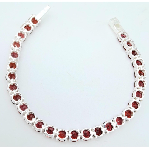 1190 - A Garnet Tennis Bracelet on 925 Silver. 19.5cm length, 0.6cm garnets, 19.62g total weight.    Ref: C... 