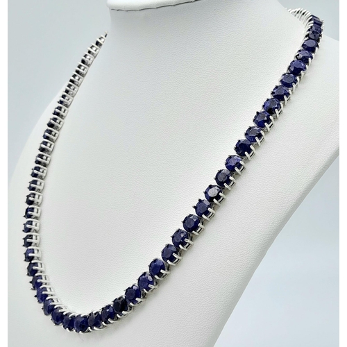 1209 - A Blue Sapphire Tennis Necklace on 925 Silver. 46.5cm length, 0.6cm sapphires, 49.4g total weight.  ... 