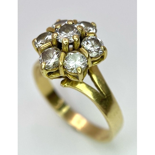 610 - A Gorgeous 18K Yellow Gold Diamond Floral Ring. Seven brilliant round cut diamonds create the perfec... 