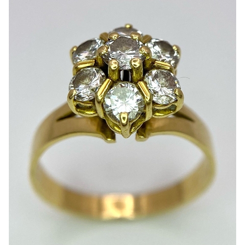 610 - A Gorgeous 18K Yellow Gold Diamond Floral Ring. Seven brilliant round cut diamonds create the perfec... 