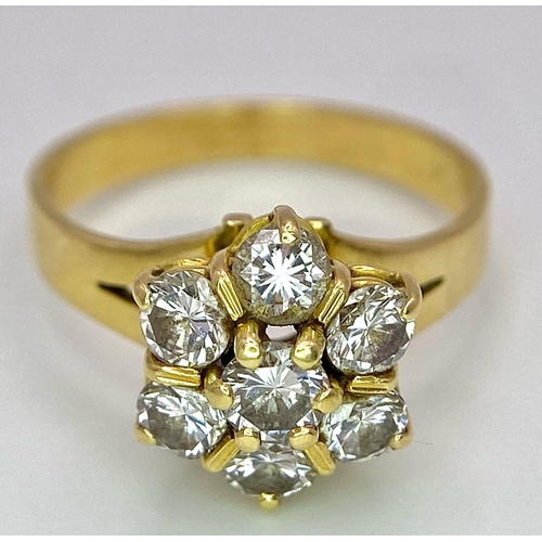 610 - A Gorgeous 18K Yellow Gold Diamond Floral Ring. Seven brilliant round cut diamonds create the perfec... 