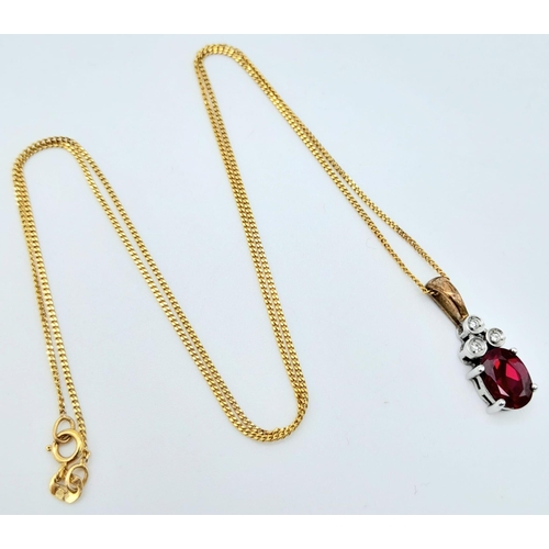 666 - A 9K YELLOW GOLD DIAMOND & RED STONE PENDANT BELIEVED TO BE RUBY & 9K GOLD CHAIN 2.8G , 46cm length.... 