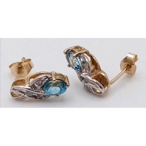 902 - A PAIR OF 9K GOLD DIAMOND AND TOPAZ EARRINGS .  1gm