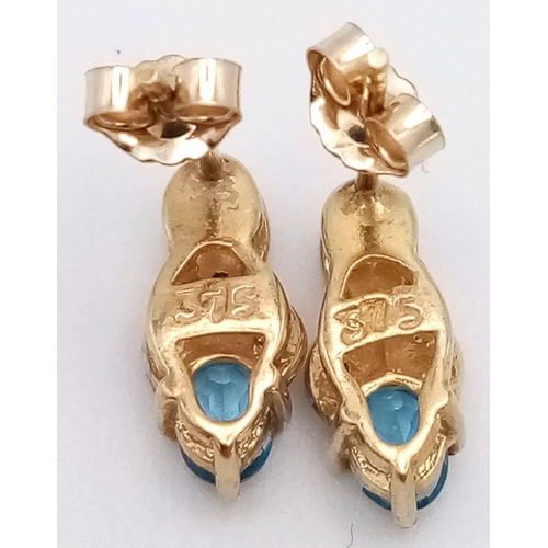 902 - A PAIR OF 9K GOLD DIAMOND AND TOPAZ EARRINGS .  1gm