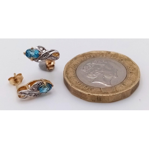 902 - A PAIR OF 9K GOLD DIAMOND AND TOPAZ EARRINGS .  1gm