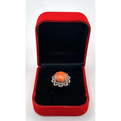 1095 - A Coral Ring with Diamond Surround on 925 Silver. 5.55ct coral, 0.75ctw diamonds. Size N/O, 5g total... 