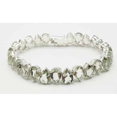 1123 - A Pear Cut Green Amethyst Tennis Bracelet Set on 925 Silver. 20cm length, 1.1cm amethysts, 25.44g to... 