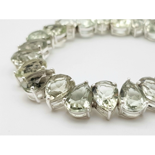 1123 - A Pear Cut Green Amethyst Tennis Bracelet Set on 925 Silver. 20cm length, 1.1cm amethysts, 25.44g to... 