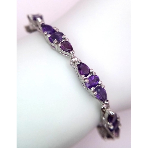 1234 - An Amethyst Tennis Bracelet on 925 Silver. 19cm length, 18.6g total weight.    Ref: CD-1206