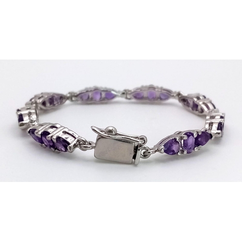 1234 - An Amethyst Tennis Bracelet on 925 Silver. 19cm length, 18.6g total weight.    Ref: CD-1206