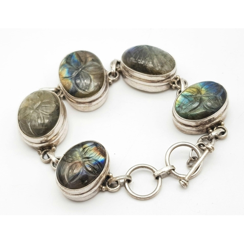 775 - A GORGEOUS STERLING SILVER  STONE SET BRACELET, BELIEVED TO BE CARVED LABRODITE STONES, T BAR CLASP,... 