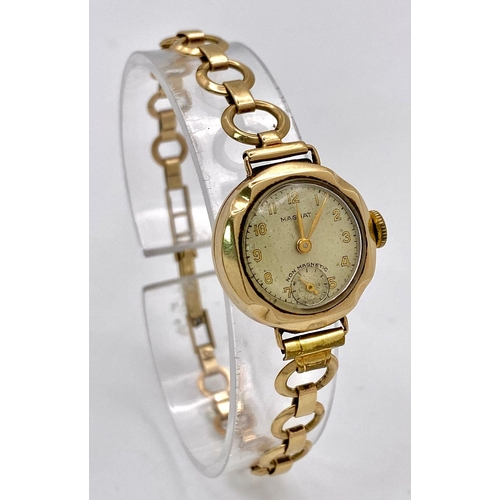 823 - A Vintage 'Magnat' 9K Gold Ladies Watch. 9k gold bracelet and case - 21mm. Cream dial with second su... 