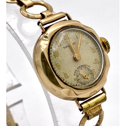 823 - A Vintage 'Magnat' 9K Gold Ladies Watch. 9k gold bracelet and case - 21mm. Cream dial with second su... 