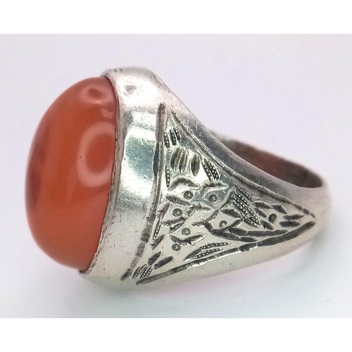 894 - A Vintage or Older Silver Carnelian Cabochon Ring Size U. Detailed Shoulders. Crown is set with a 2c... 