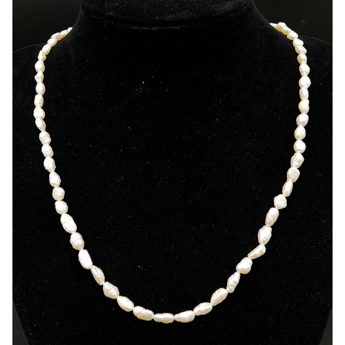 932 - A Vintage Rice Pearl Necklace with 9K Gold Clasp. 56cm length.