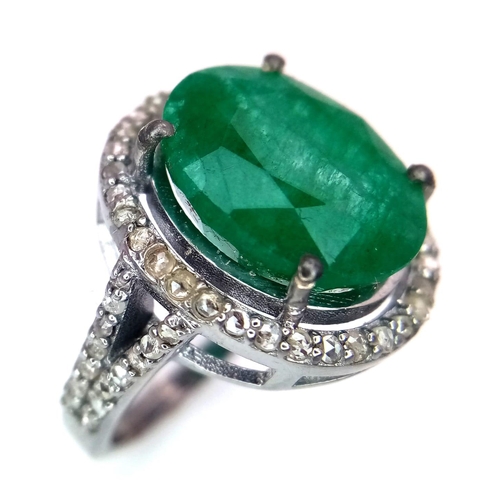 961 - An Emerald Ring with a Halo of Diamonds on 925 Silver. 7.55ct emerald, 0.67ctw diamonds. Size N, 4.9... 