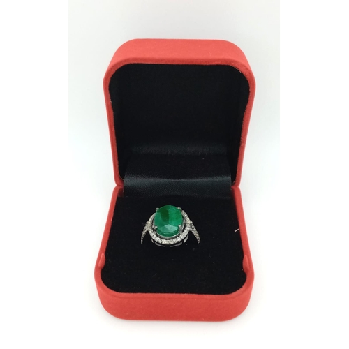 961 - An Emerald Ring with a Halo of Diamonds on 925 Silver. 7.55ct emerald, 0.67ctw diamonds. Size N, 4.9... 