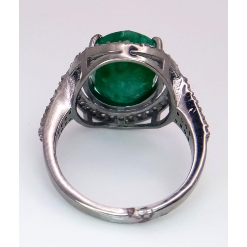 961 - An Emerald Ring with a Halo of Diamonds on 925 Silver. 7.55ct emerald, 0.67ctw diamonds. Size N, 4.9... 