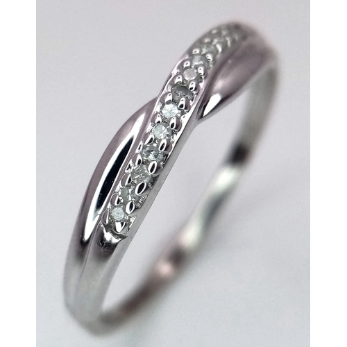 993 - A 9K WHITE GOLD DIAMOND SET CROSSOVER RING 1G SIZE L

SC 4025