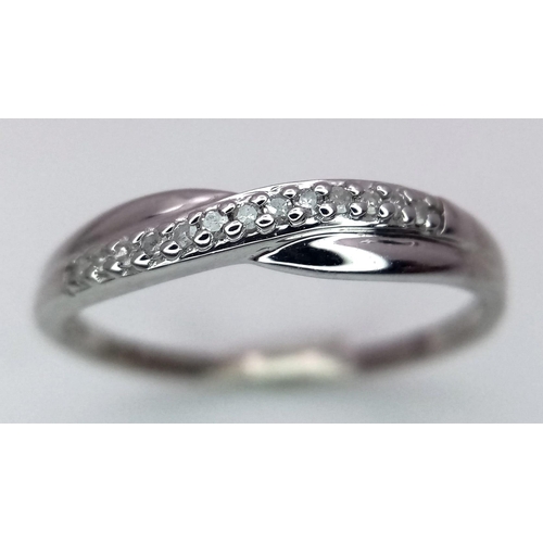 993 - A 9K WHITE GOLD DIAMOND SET CROSSOVER RING 1G SIZE L

SC 4025