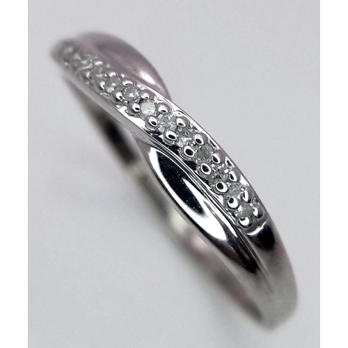 993 - A 9K WHITE GOLD DIAMOND SET CROSSOVER RING 1G SIZE L

SC 4025