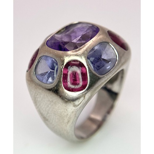 45 - A Chanel Designer 18K White Gold and Amethyst and Garnet Ring. Rectangular cut central amethyst with... 