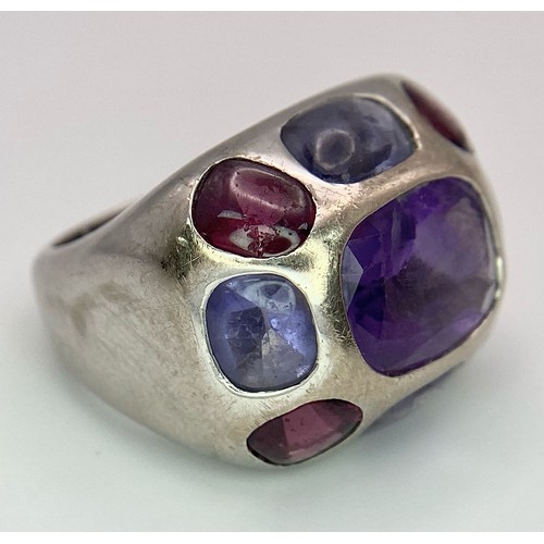 45 - A Chanel Designer 18K White Gold and Amethyst and Garnet Ring. Rectangular cut central amethyst with... 