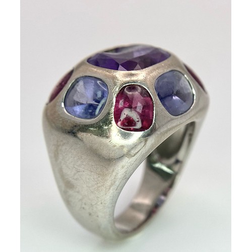 45 - A Chanel Designer 18K White Gold and Amethyst and Garnet Ring. Rectangular cut central amethyst with... 