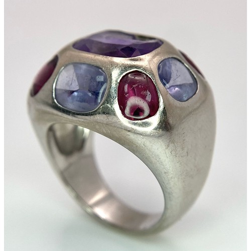 45 - A Chanel Designer 18K White Gold and Amethyst and Garnet Ring. Rectangular cut central amethyst with... 