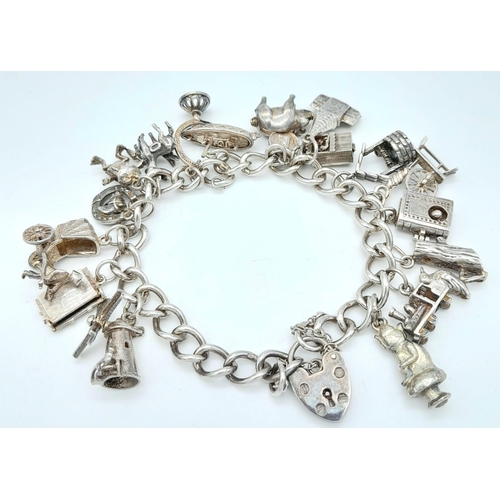 1382 - A vintage sterling silver multiple charm bracelet. Total weight 51.7G. Please see photos for more de... 