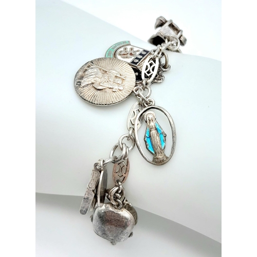 1205 - A vintage sterling silver multiple charm bracelet. Total weight 34.7G. Please see photos for details... 