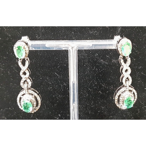 1228 - A Pair of Emerald and Diamond Drop Earrings on 925 Silver. Approximately 5ctw emeralds, 2.5ctw diamo... 