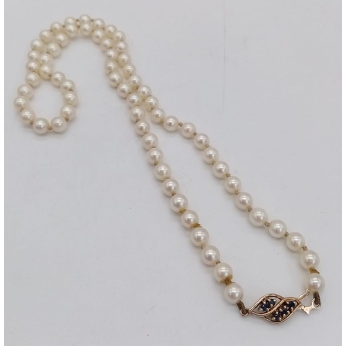 1299 - A Vintage Pearl Necklace with Gold and Sapphire Clasp. 43cm