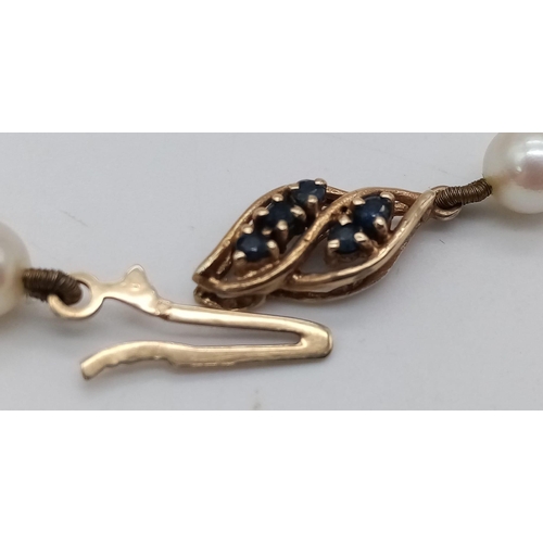 1299 - A Vintage Pearl Necklace with Gold and Sapphire Clasp. 43cm