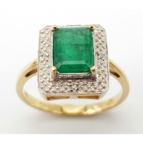 1339 - A 9K GOLD RING WITH 2.5ct NATURAL EMERALD SURROUNDED BY DIAMONDS.     3.8gms   size O