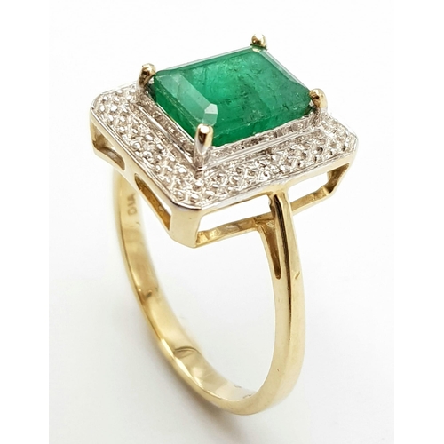 1339 - A 9K GOLD RING WITH 2.5ct NATURAL EMERALD SURROUNDED BY DIAMONDS.     3.8gms   size O