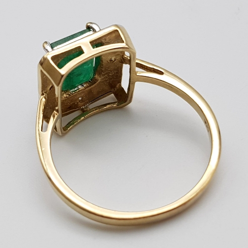 1339 - A 9K GOLD RING WITH 2.5ct NATURAL EMERALD SURROUNDED BY DIAMONDS.     3.8gms   size O