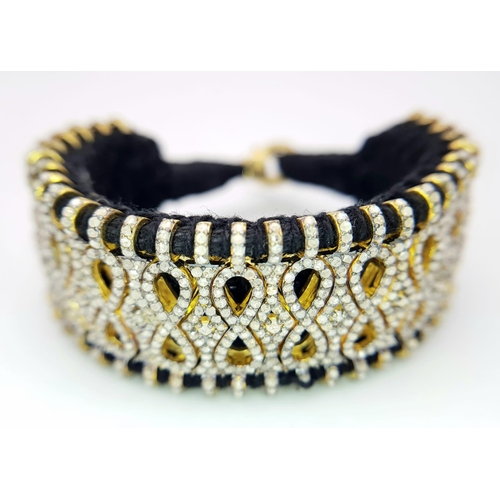 1202 - A Brilliantly Unique Handcrafted Designer Diamond Bracelet. A black woven textile bracelet strap ado... 