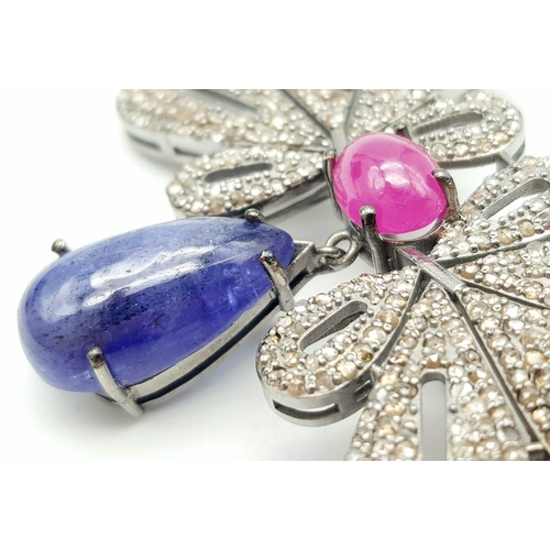 1229 - A Tanzanite, Ruby and Diamond Butterfly Brooch. 12.7ct tanzanite, 3.55ct ruby, 5.40ctw diamonds. 6.3... 