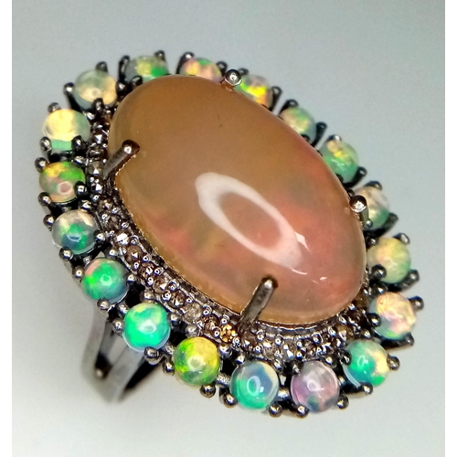 1216 - An Opal Ring with Diamond and Opal Surround on 925 Silver. 8.70ct centre stone (2cm), 2.10ctw opal a... 