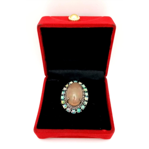 1216 - An Opal Ring with Diamond and Opal Surround on 925 Silver. 8.70ct centre stone (2cm), 2.10ctw opal a... 