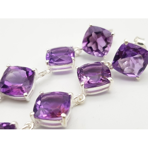 1243 - A Pair of Amethyst Drop Earrings on 925 Silver. 6.4cm length, 1.1cm amethysts, 13g total weight.    ... 