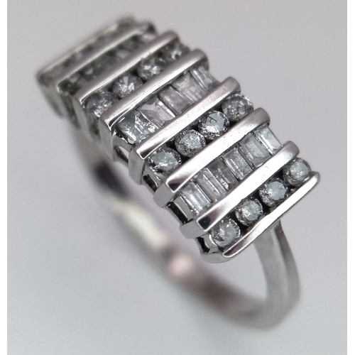 1332 - A 9K WHITE GOLD RING WITH INTICATELY SET DIAMONDS .   2.7gms   size N