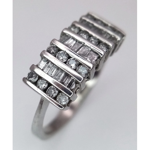 1332 - A 9K WHITE GOLD RING WITH INTICATELY SET DIAMONDS .   2.7gms   size N