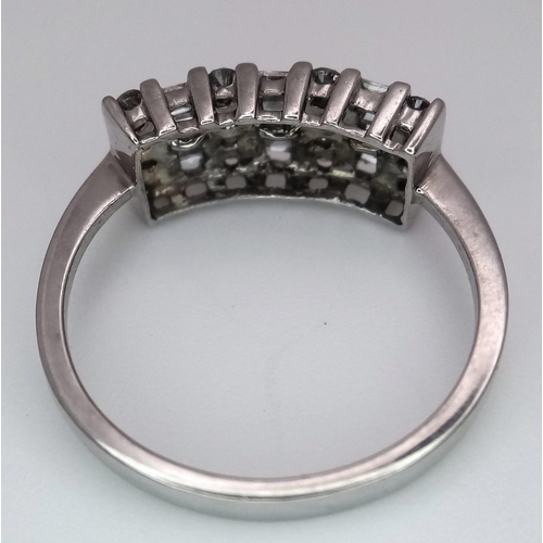 1332 - A 9K WHITE GOLD RING WITH INTICATELY SET DIAMONDS .   2.7gms   size N