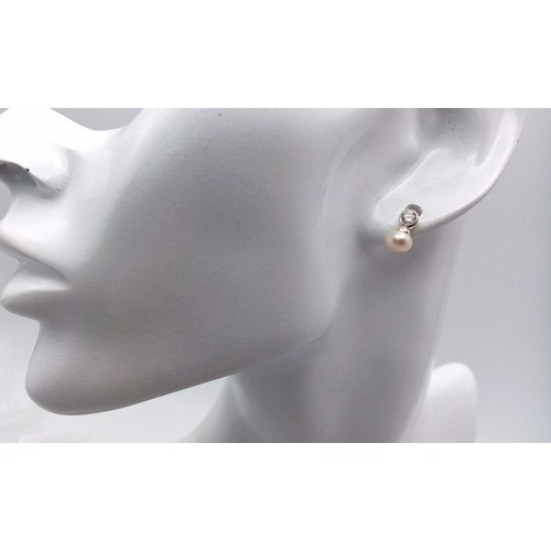 1230 - A fancy pair of 925 silver Zirconia and pearl earrings. Total weight 1.35G.